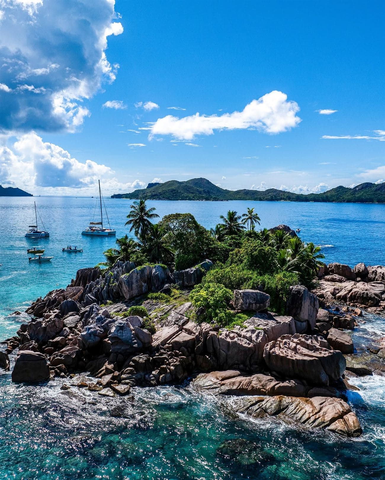 St Pierre islet in Seychelles, granite boulders and palm trees surrounded by turquoise water